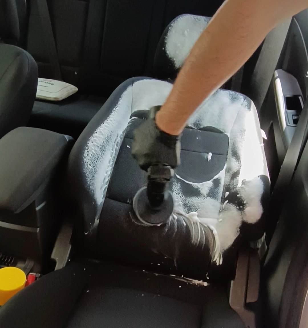 Seat being extraction-cleaned